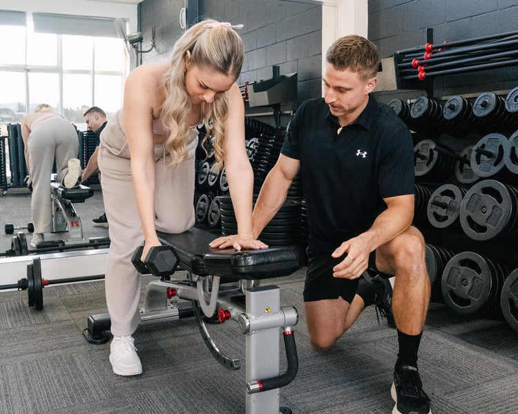 A person providing an in-person personal training session